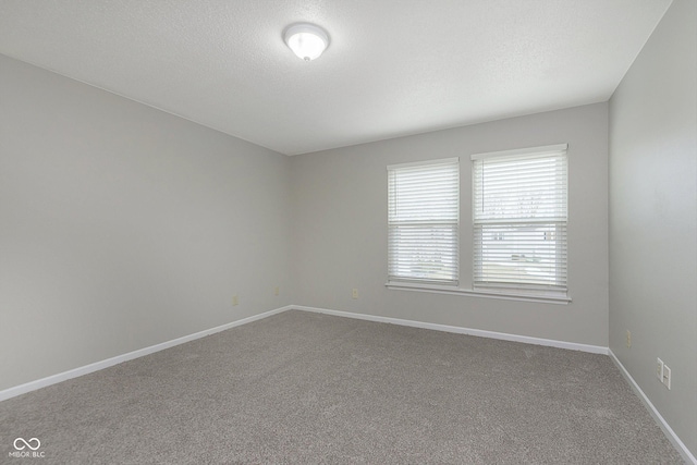 carpeted spare room featuring a textured ceiling