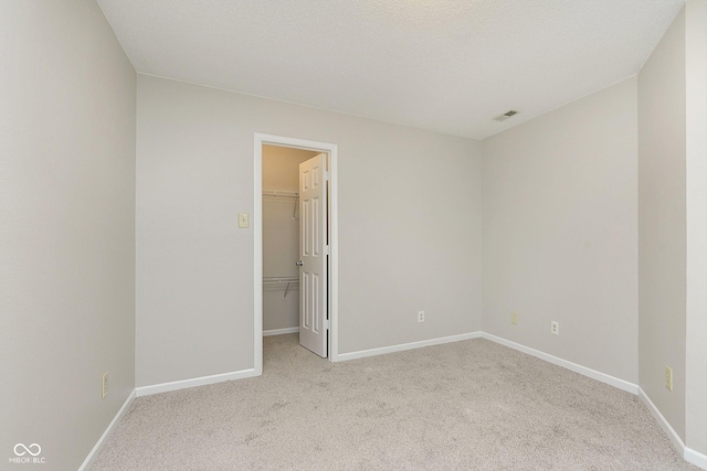 empty room featuring light carpet