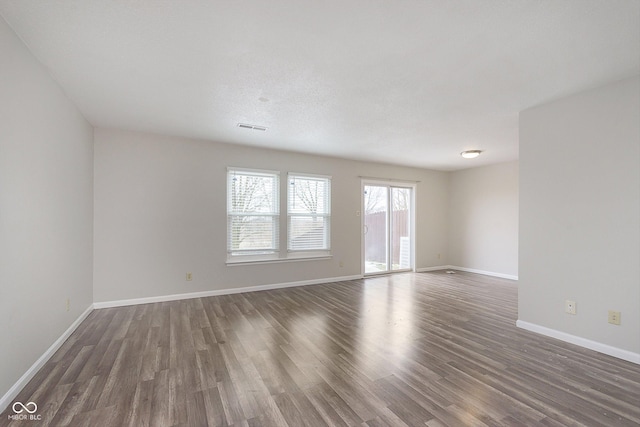 spare room with dark hardwood / wood-style flooring