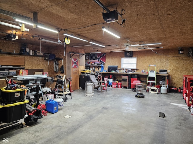 garage featuring a garage door opener and a workshop area