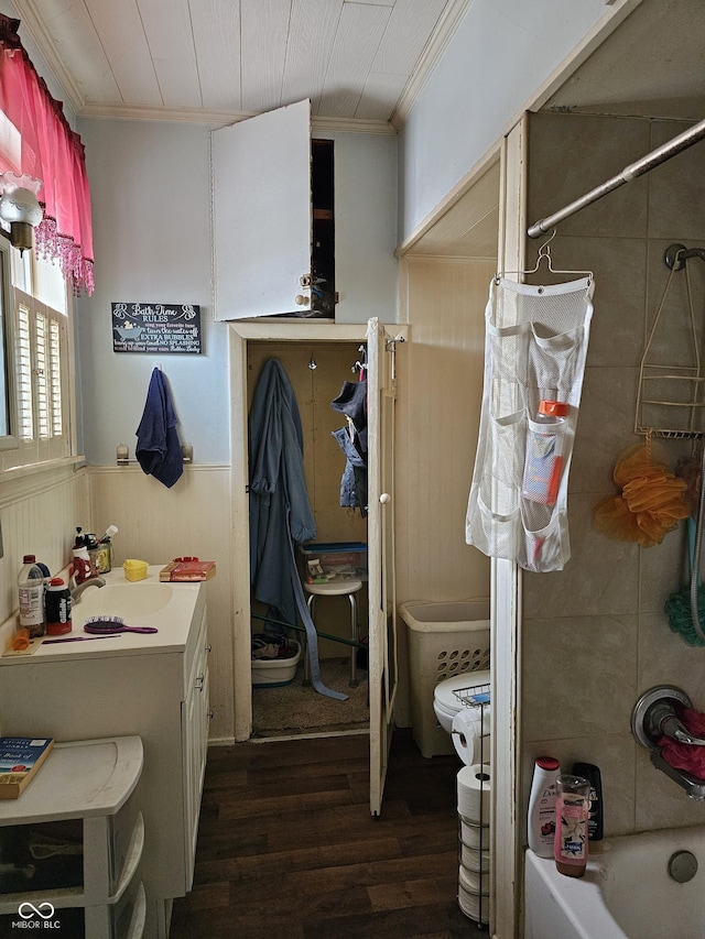 bathroom featuring vanity, hardwood / wood-style floors, ornamental molding, and shower / washtub combination