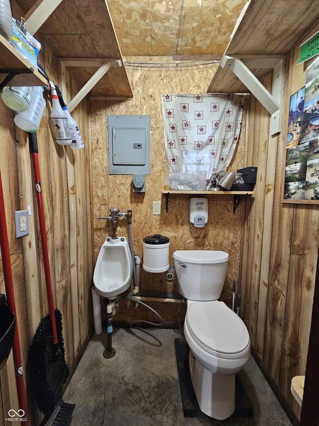 bathroom with a bidet, toilet, and electric panel