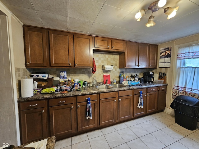 kitchen featuring sink, decorative backsplash, and light tile patterned floors