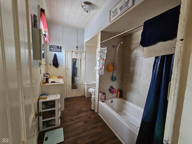 bathroom featuring hardwood / wood-style flooring, ornamental molding, and shower / bathtub combination with curtain