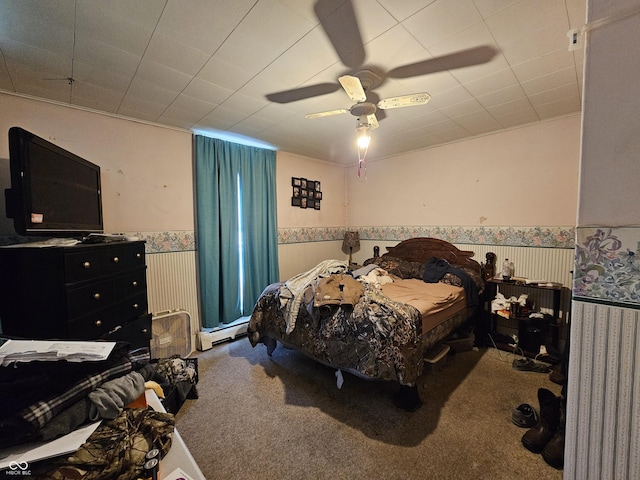 carpeted bedroom with baseboard heating and ceiling fan