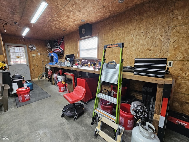 misc room featuring concrete flooring and a workshop area