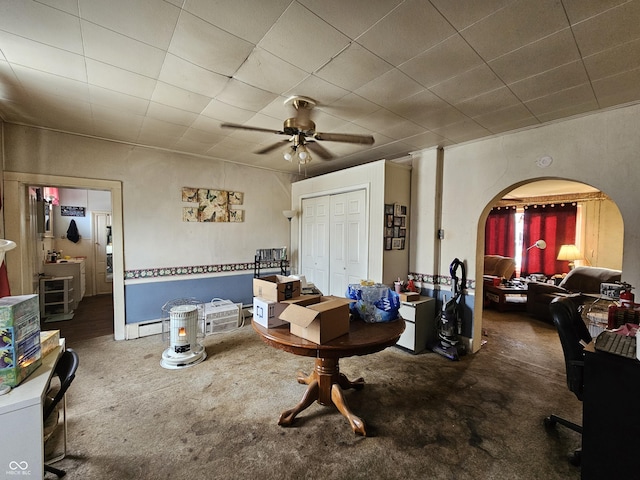 carpeted living room featuring ceiling fan and baseboard heating