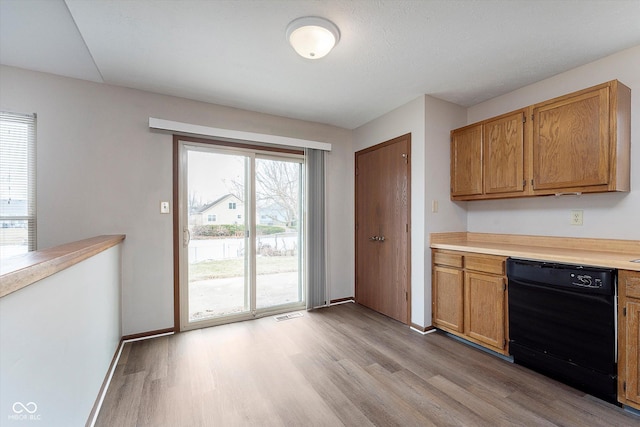 kitchen featuring light hardwood / wood-style flooring and black dishwasher