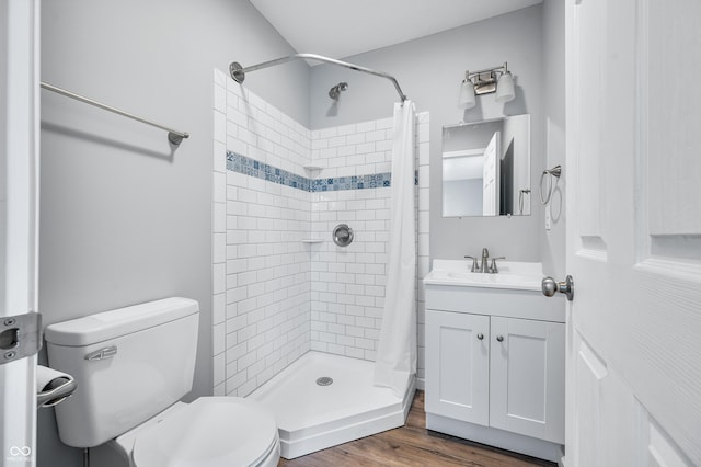 bathroom with hardwood / wood-style flooring, vanity, toilet, and a shower with curtain