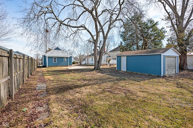 view of yard with a garage and an outdoor structure