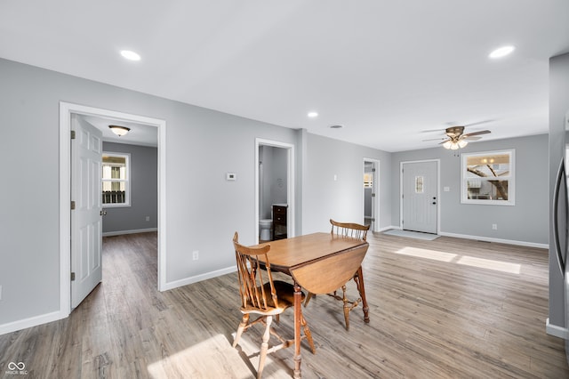 dining space featuring ceiling fan and light wood-type flooring