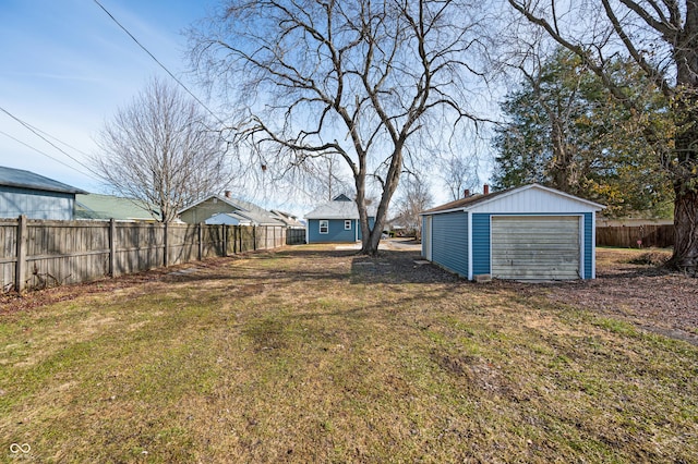 view of yard featuring a garage and an outdoor structure