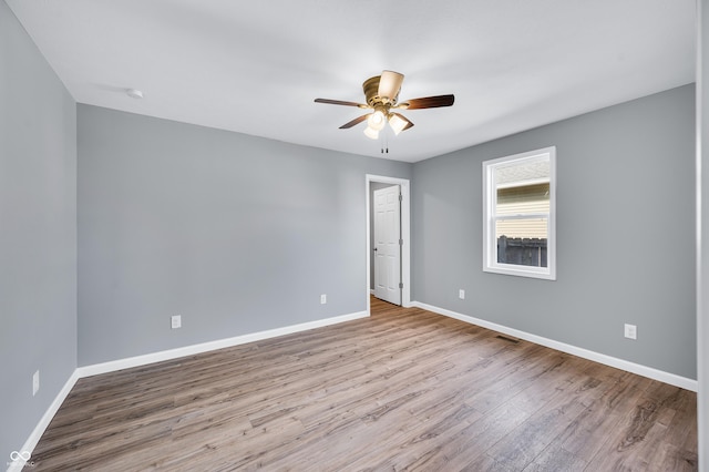 spare room featuring ceiling fan and light wood-type flooring