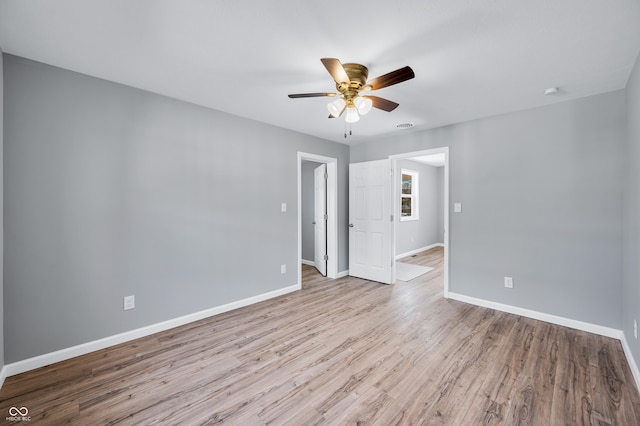 unfurnished room featuring ceiling fan and light wood-type flooring