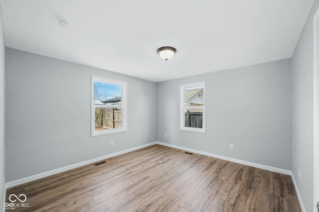 unfurnished room with wood-type flooring