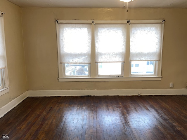 empty room with dark hardwood / wood-style floors