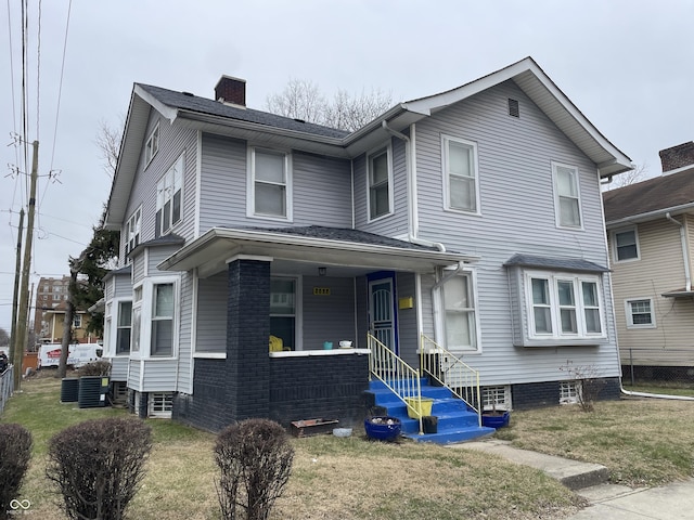 view of front facade with covered porch and a front lawn