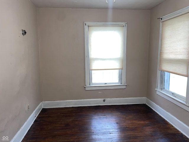 unfurnished room featuring dark hardwood / wood-style flooring