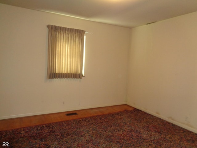 unfurnished room featuring hardwood / wood-style floors