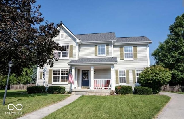 view of front of property with covered porch and a front lawn