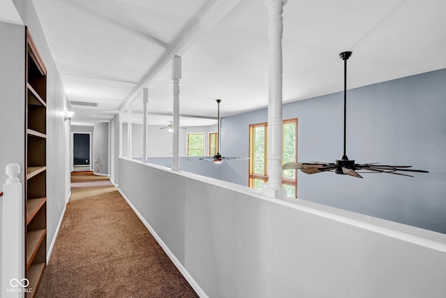 hall featuring carpet floors, baseboards, and visible vents