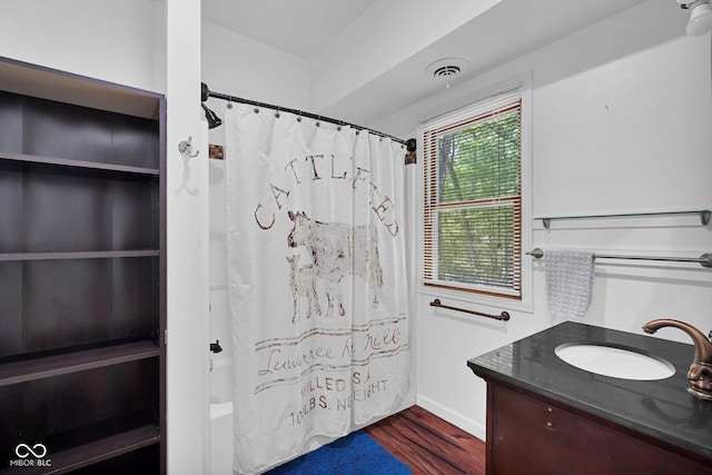 bathroom with visible vents, baseboards, wood finished floors, and vanity