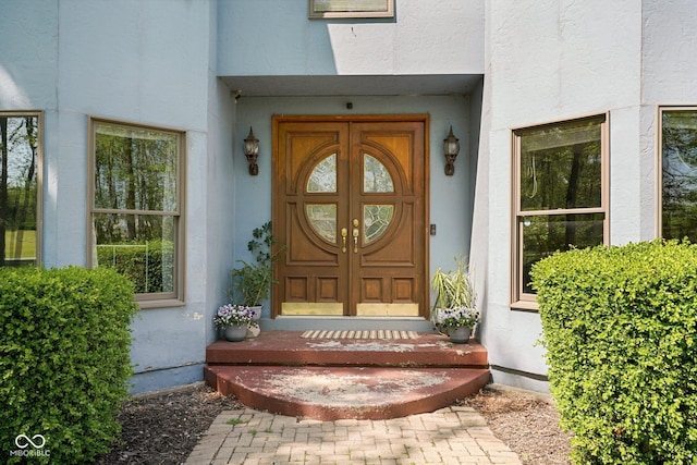 property entrance with stucco siding
