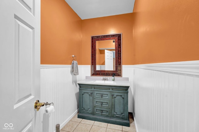 bathroom featuring vanity, tile patterned floors, and a wainscoted wall