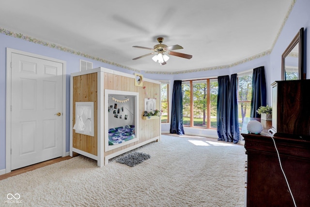 unfurnished bedroom featuring baseboards, multiple windows, a ceiling fan, and visible vents