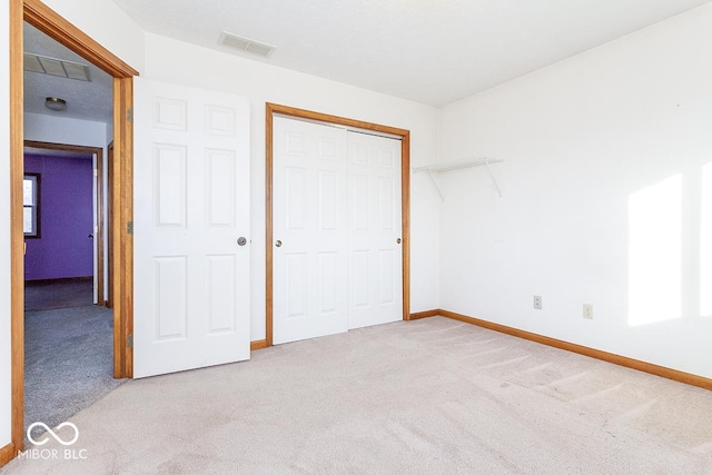 unfurnished bedroom featuring a closet and carpet floors