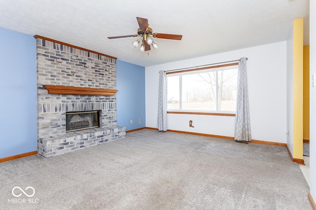 unfurnished living room featuring a fireplace, carpet flooring, a textured ceiling, and ceiling fan