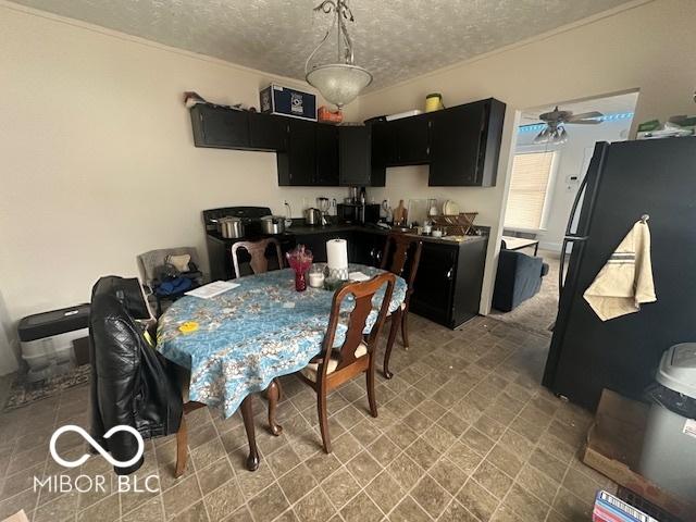 dining room with ceiling fan and a textured ceiling