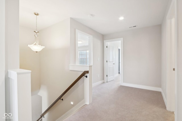 corridor with light colored carpet