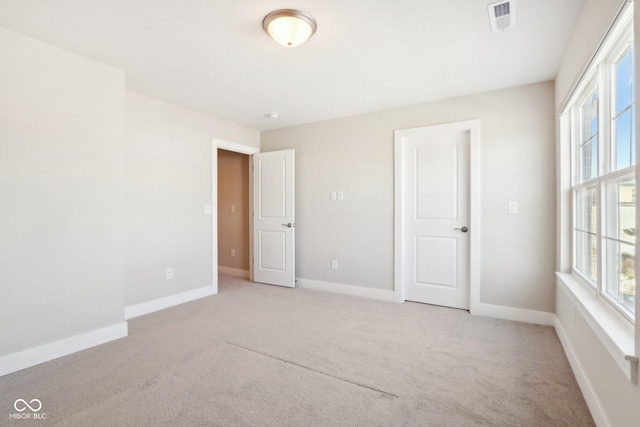 empty room featuring light carpet