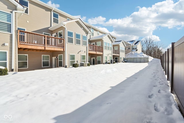 view of snow covered back of property