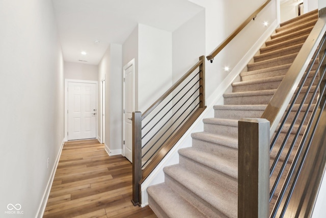 stairs featuring wood-type flooring