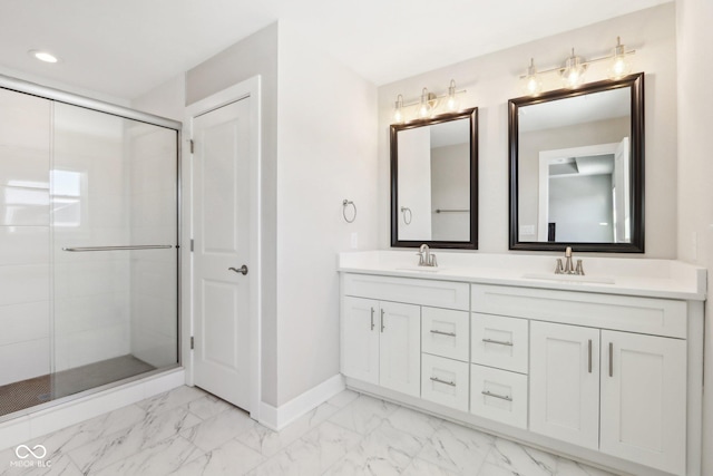 bathroom featuring vanity and a shower with door