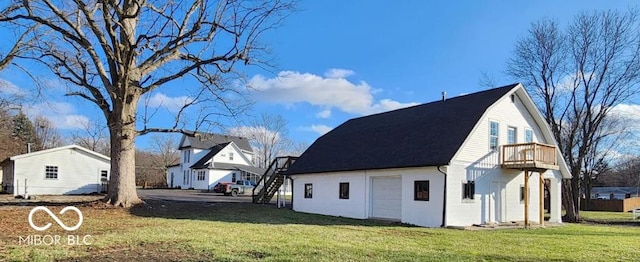 view of home's exterior with a lawn and a balcony