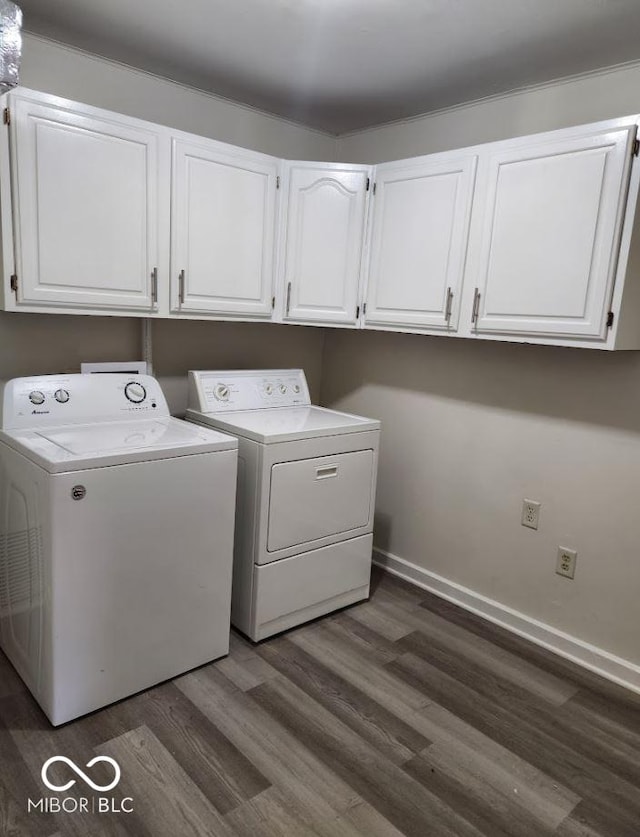 washroom with cabinets, dark hardwood / wood-style floors, and washer and dryer