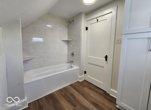 bathroom with wood-type flooring and tiled shower / bath