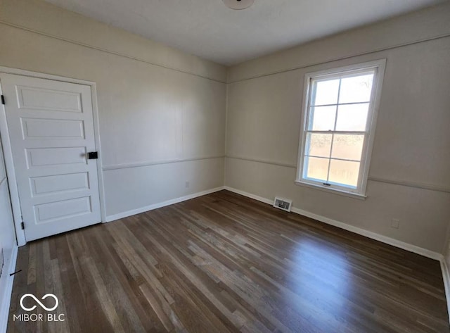 spare room featuring dark hardwood / wood-style floors