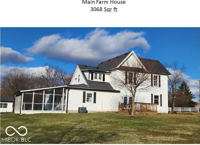 back of property with a yard, central AC, and a sunroom