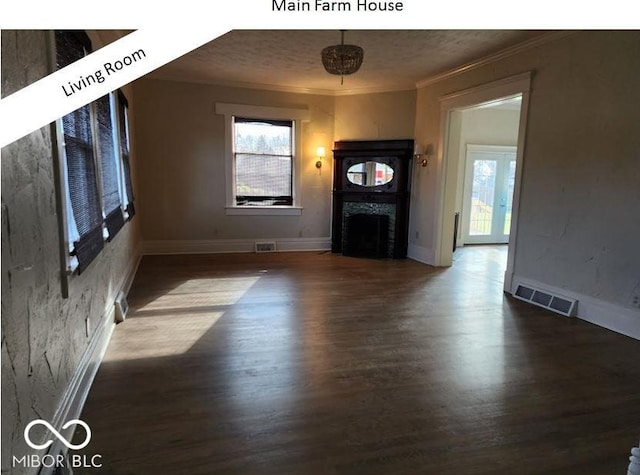 unfurnished living room featuring ornamental molding, dark hardwood / wood-style floors, and a wealth of natural light