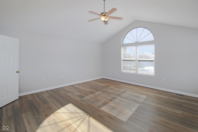 spare room with dark wood-type flooring, ceiling fan, and vaulted ceiling