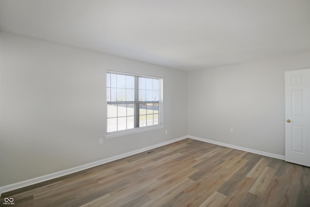 spare room featuring hardwood / wood-style flooring