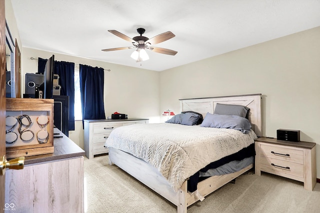 bedroom featuring light colored carpet and ceiling fan