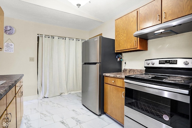 kitchen with appliances with stainless steel finishes and a textured ceiling