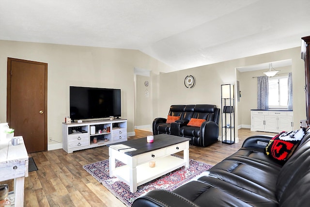 living room with lofted ceiling and hardwood / wood-style floors