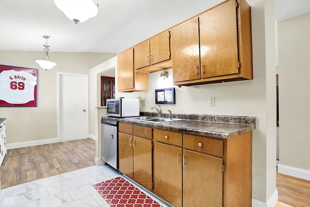 kitchen with pendant lighting, sink, and stainless steel appliances