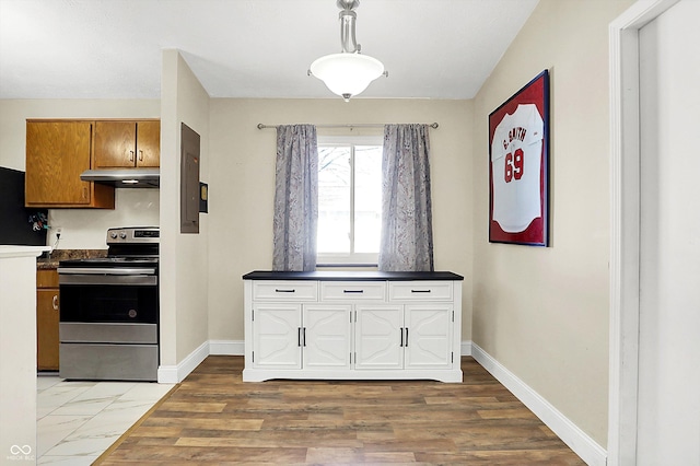 kitchen with electric range and light hardwood / wood-style flooring